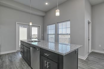 the kitchen of a new home with a granite counter top